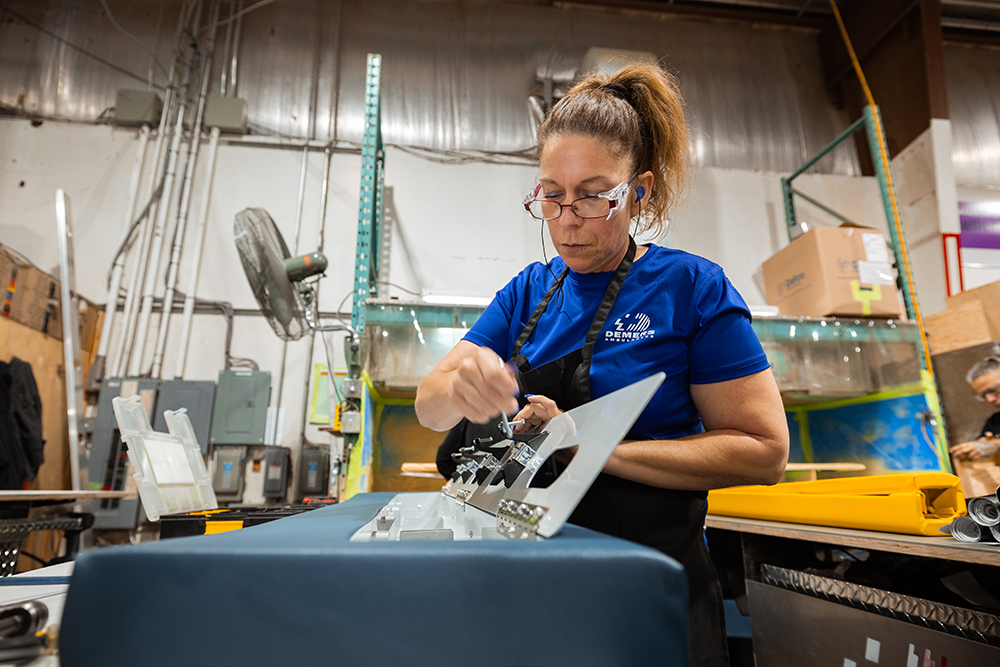 Demers employee working on an ambulance seat inside a manufacturing facility