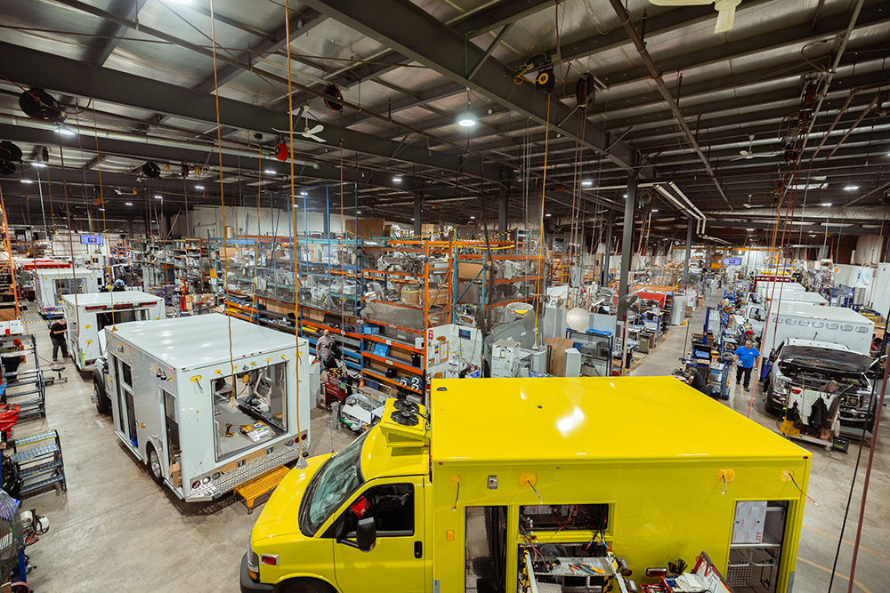 Interior view of Demers’ large manufacturing facility with ambulances and equipment throughout the space