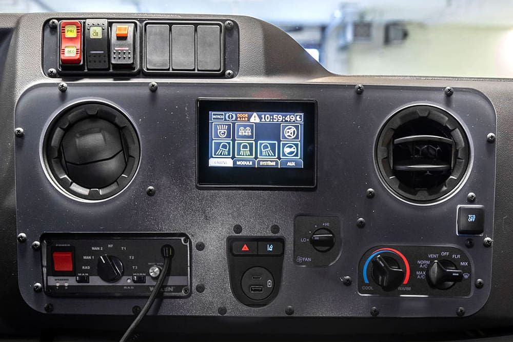 Demers ambulance dashboard control panel featuring dual air vents, climate controls, rocker switches, and a central touchscreen display for interior lighting and system functions