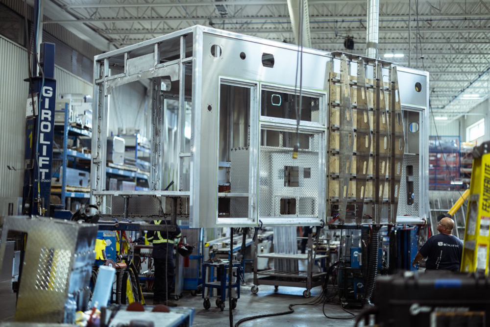 Exterior view of an aluminum ambulance module frame during production.